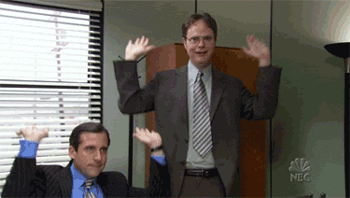 A gif with two people throwing their hands up in the air.